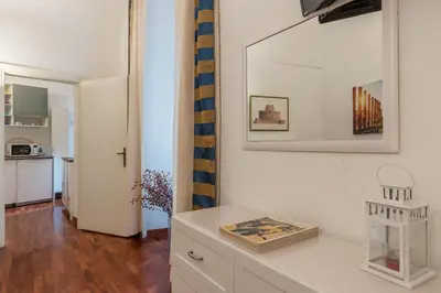a living room with a white cabinet and a mirror at CS Piazza Venezia Apartment in Rome