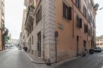 a building on the side of a city street at CS Piazza Venezia Apartment in Rome