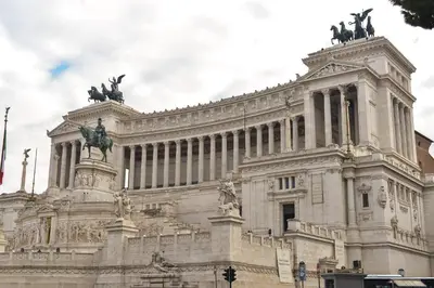 a building with statues on the top of it at CS Piazza Venezia Apartment in Rome