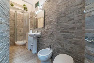 a bathroom with a toilet and a sink and a shower at CS Piazza Venezia Apartment in Rome