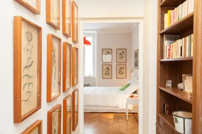 a bedroom with a bed in a room with bookshelves at Lovely House Rome in Rome