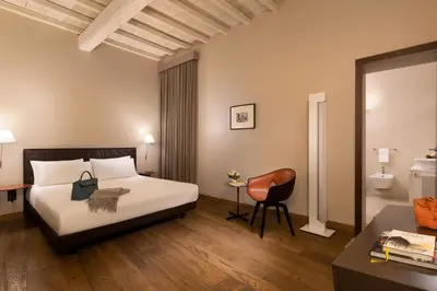 a bedroom with a bed and a desk and a chair at Palazzo Scanderbeg in Rome