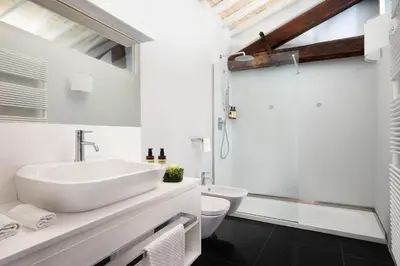 a white bathroom with a sink and a toilet at Palazzo Scanderbeg in Rome