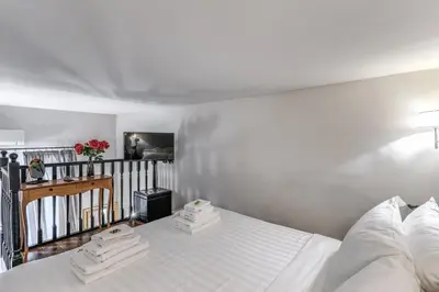 a bedroom with a white bed with towels on it at Operà Suites Pinciana in Rome