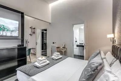 a bedroom with a bed with two towels on it at Operà Suites Pinciana in Rome