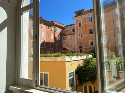 a window with a view of a building at Basilica Hotel in Rome