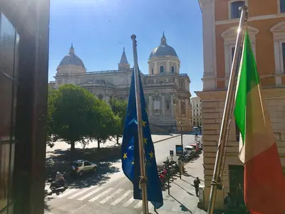 two flags are in front of a building at Basilica Hotel in Rome