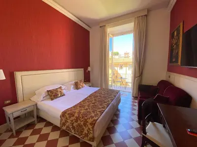 a hotel room with a bed and a window at Basilica Hotel in Rome