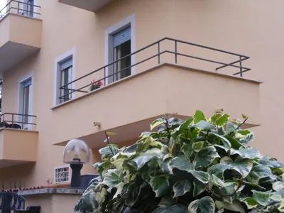 a plant in front of a building with a balcony at Gli Alloggi Di Papà in Rome