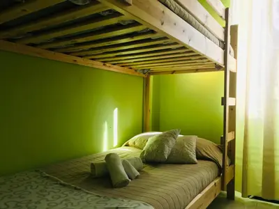 a bedroom with a bunk bed with green walls at Gli Alloggi Di Papà in Rome