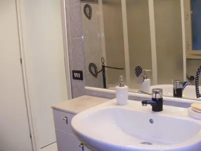 a bathroom with a sink and a mirror at Gli Alloggi Di Papà in Rome