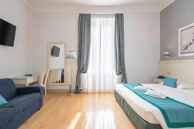 a hotel room with a bed and a couch at Domus Castrense in Rome