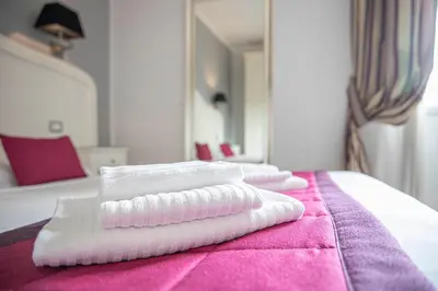 a group of towels sitting on top of a bed at Domus Castrense in Rome
