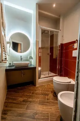 a bathroom with a sink and a toilet and a mirror at MyBedCavour in Rome