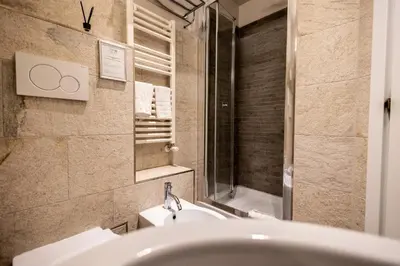 a bathroom with a sink and a mirror at MyBedCavour in Rome