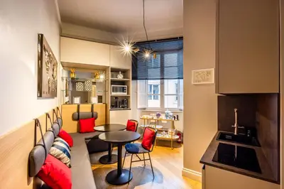 a kitchen and living room with a couch and a table at MyBedCavour in Rome