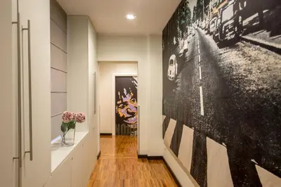 a hallway with black and white photographs on the wall at Suitedreams in Rome