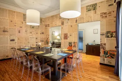 a dining room with a black table and chairs at Suitedreams in Rome