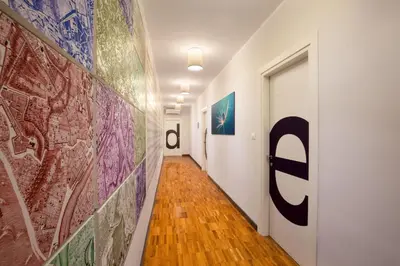 a hallway with paintings on the walls of a room at Suitedreams in Rome