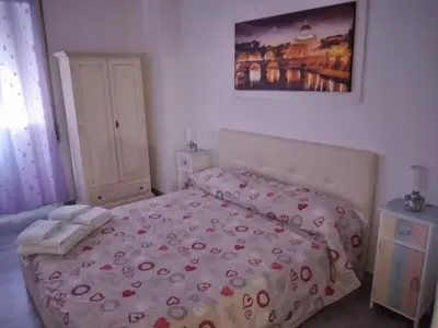 a bedroom with a bed and a painting on the wall at Dal Pontefice in Rome