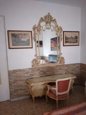 a mirror on a wall with a desk and a chair at Dal Pontefice in Rome