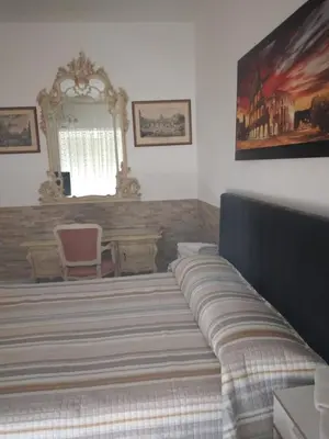 a bedroom with a large bed with a large mirror at Dal Pontefice in Rome