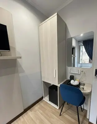 a small room with a desk and a blue chair at Residenza Cola Di Rienzo - Suite In Rome in Rome
