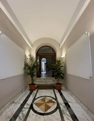 a hallway with two potted plants in a building at Residenza Cola Di Rienzo - Suite In Rome in Rome