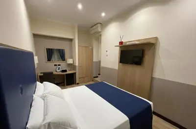 a hotel room with a bed and a television at Residenza Cola Di Rienzo - Suite In Rome in Rome
