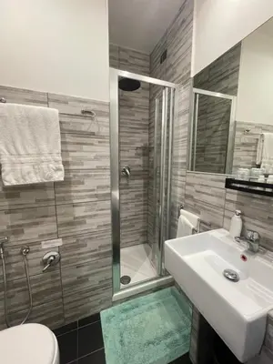 a bathroom with a sink and a shower and a toilet at Residenza Cola Di Rienzo - Suite In Rome in Rome