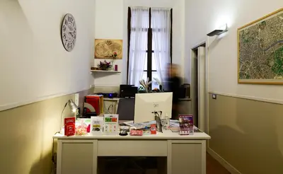 a desk in a room with a table with books on it at Spagna Ave in Rome