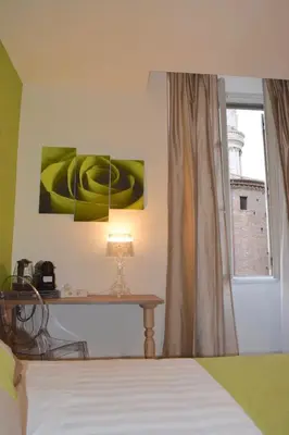 a bedroom with a bed and a window and a lamp at Spagna Ave in Rome