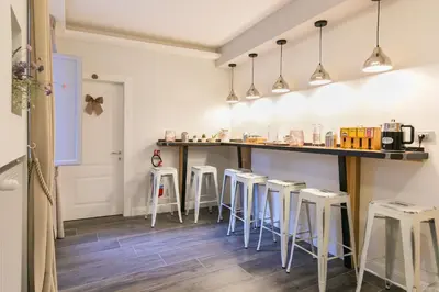 a row of stools in a room with a counter at Spagna Ave in Rome