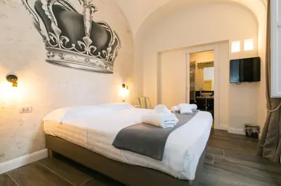 a bedroom with a bed with a crown on the wall at Spagna Ave in Rome