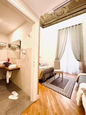 a room with a bedroom with a desk and a bed at Spagna Ave in Rome