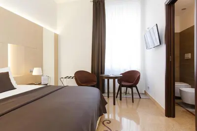 a bedroom with a bed and a bathroom with a tub at Domus Terenzio in Rome