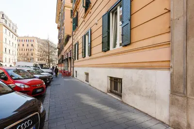 a narrow street with cars parked next to a building at Domus Terenzio in Rome