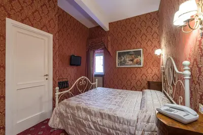 a bedroom with a bed and a phone on a table at Residenza Ave Roma in Rome