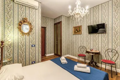 a dining room with blue and white wallpaper at Residenza Ave Roma in Rome