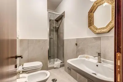 a bathroom with a sink and a toilet and a mirror at Residenza Ave Roma in Rome