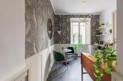 a hallway with a table and chairs in a room at Residenza Vaticana in Rome