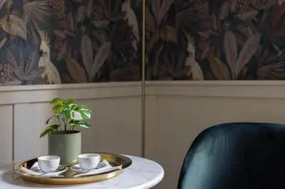 a table with a tray and two cups and a plant at Residenza Vaticana in Rome