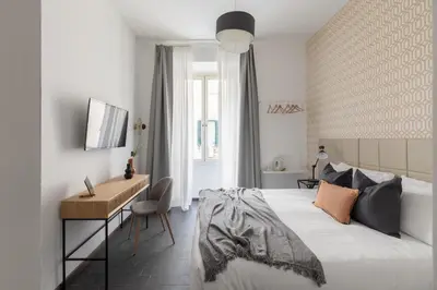 a bedroom with a bed and a desk and a desk at Residenza Vaticana in Rome
