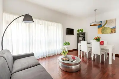 a living room with a couch and a table at HOME SWEET HOLIDAY srl in Rome