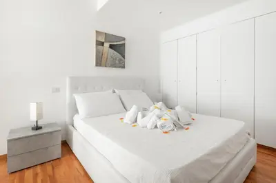 a bedroom with a white bed with two stuffed animals on it at HOME SWEET HOLIDAY srl in Rome