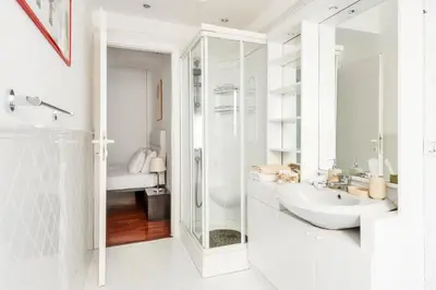 a white bathroom with a sink and a shower at HOME SWEET HOLIDAY srl in Rome