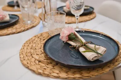 a table with a blue plate with a flower on it at MoMo Vatican Museums in Rome