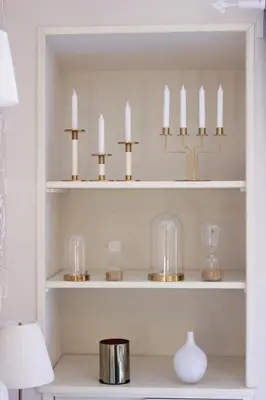 a room with white shelves with candles and a lamp at MoMo Vatican Museums in Rome