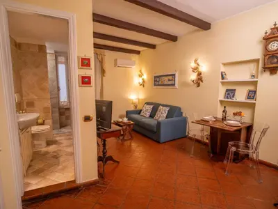 a living room with a couch and a table at Navona Little Home in Rome