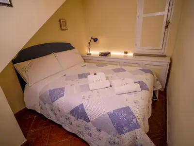 a bedroom with a bed with two towels on it at Navona Little Home in Rome